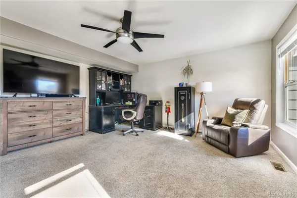 a view of a livingroom with furniture and a flat screen tv