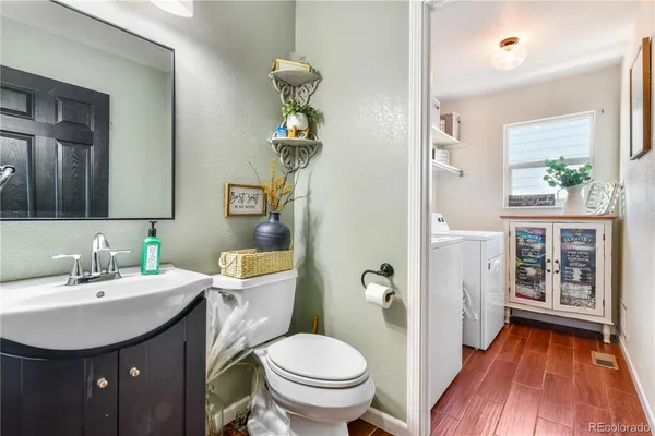 a bathroom with a toilet a sink and mirror