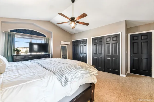 a bedroom with a bed and a large mirror with a flat tv screen