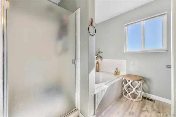 a bathroom with a bathtub and a shower