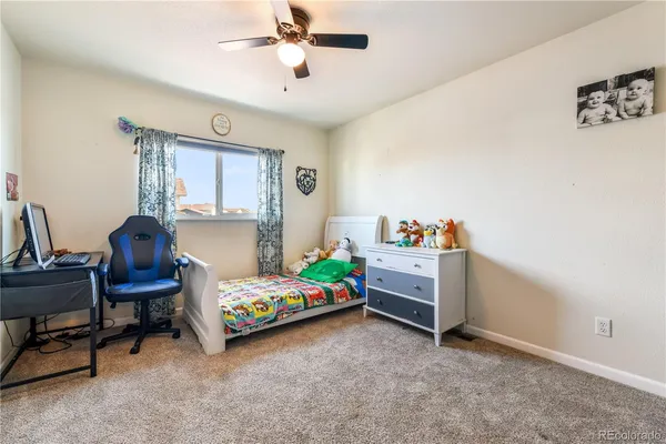 a bedroom with a bed and a desk