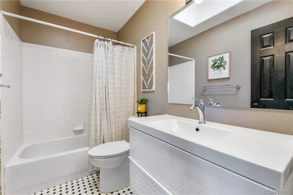 a bathroom with a sink a toilet and a bathtub