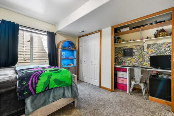 a bedroom with bed and a flat tv screen