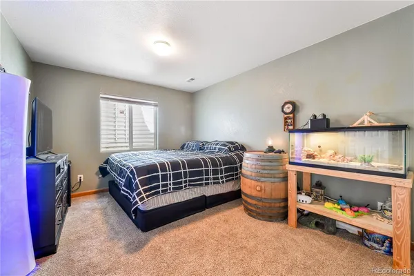 a bedroom with a bed and a dresser