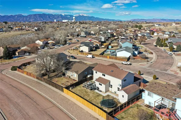 an aerial view of a house with a swimming pool