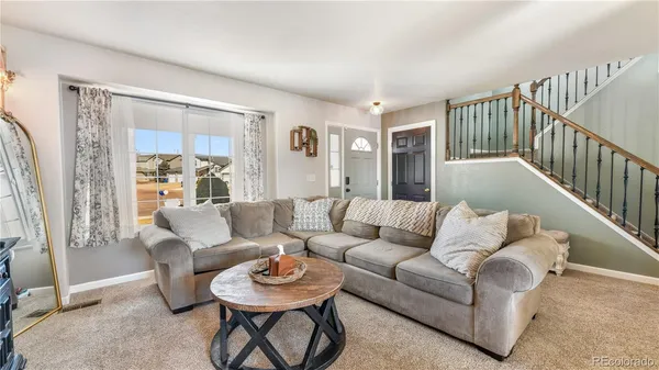 a living room with furniture and a large window