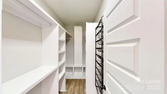 a view of staircase with white walls and a window