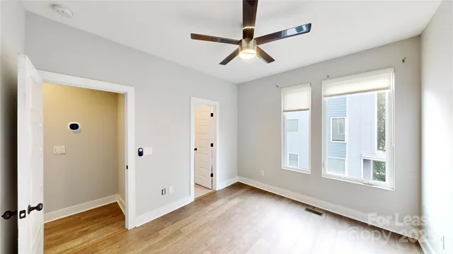 a view of a livingroom with a ceiling fan and window