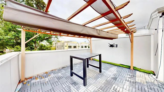 a view of a porch with furniture and a yard