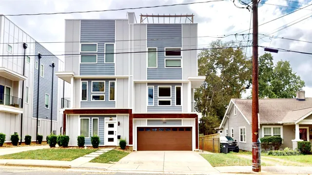 a front view of a building with a garden and plants