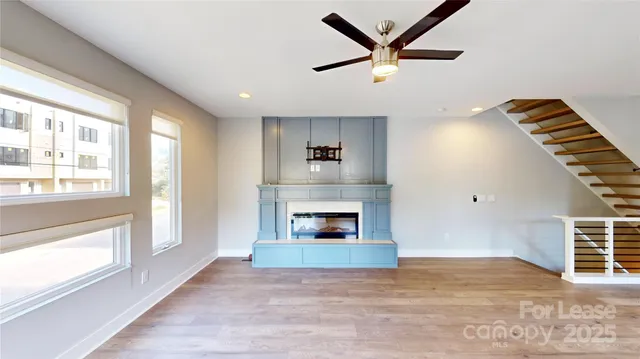 a view of an empty room with a fireplace and a window