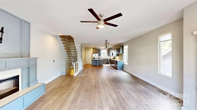 a view of a livingroom with a hardwood floor and a ceiling fan