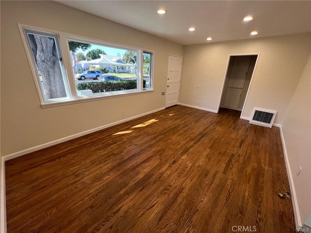 8400 Fordham Road Westchester, CA 90045 - Photo 3 of 25 a view of an empty room with wooden floor and a window