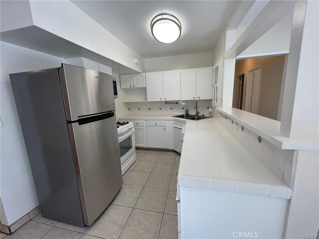 8400 Fordham Road Westchester, CA 90045 - Photo 5 of 25 a kitchen with a refrigerator a stove top oven and a refrigerator