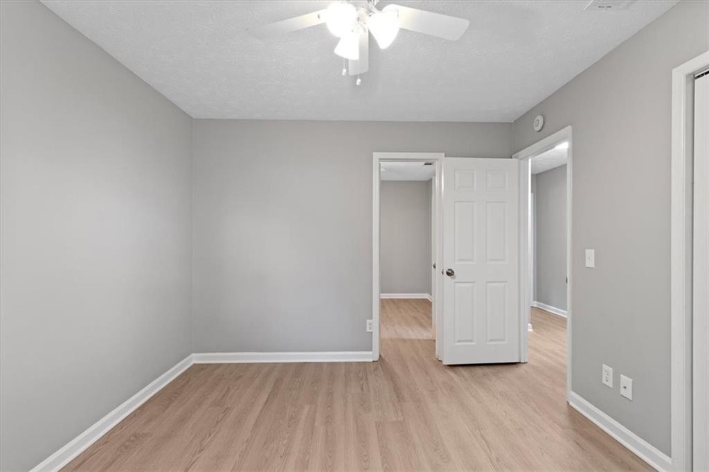 894 Five Forks Trickum Road Southwest Lawrenceville, GA 30046 - Photo 13 of 28 wooden floor in an empty room with a window