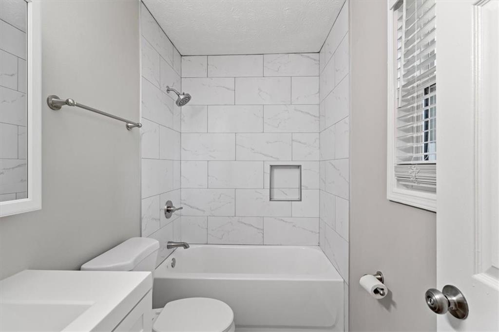 894 Five Forks Trickum Road Southwest Lawrenceville, GA 30046 - Photo 16 of 28 a bathroom with a toilet and a bath tub