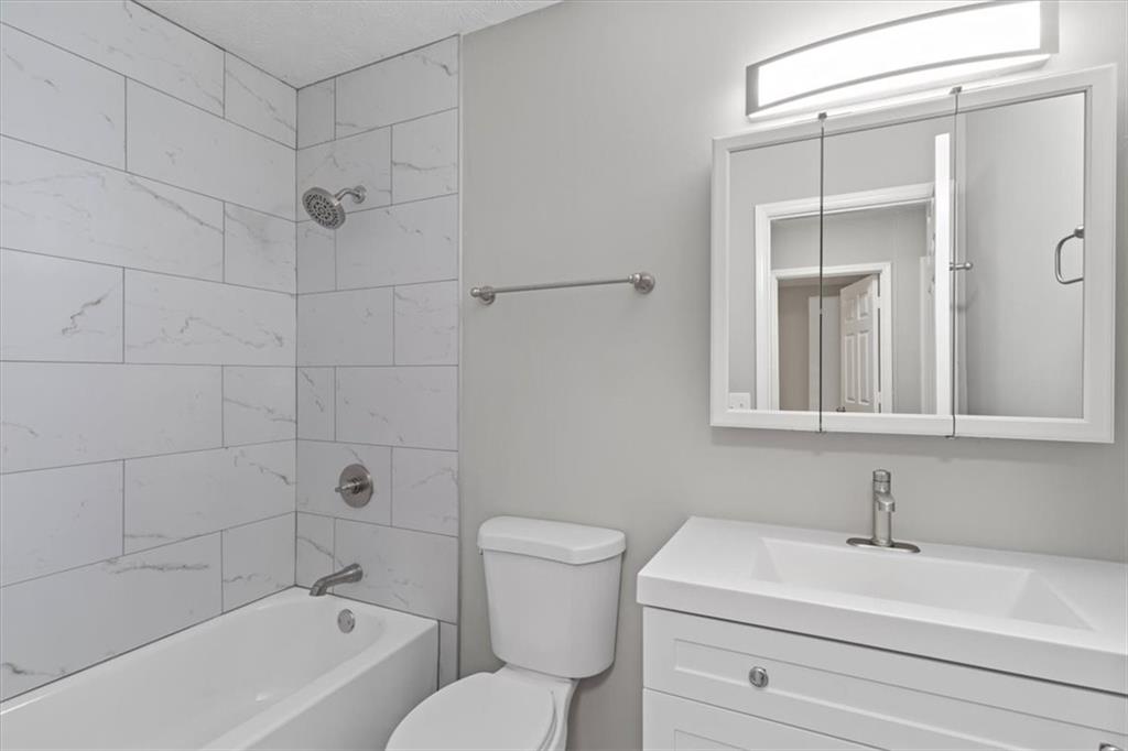 894 Five Forks Trickum Road Southwest Lawrenceville, GA 30046 - Photo 17 of 28 a bathroom with a sink a toilet and shower