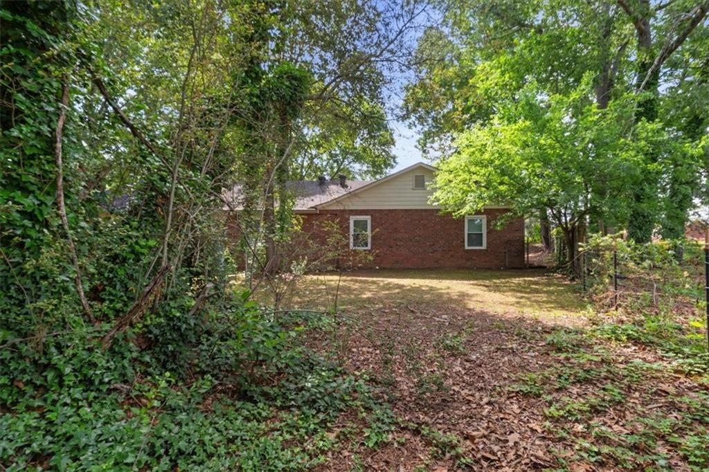 894 Five Forks Trickum Road Southwest Lawrenceville, GA 30046 - Photo 20 of 28 a backyard of a house with lots of green space