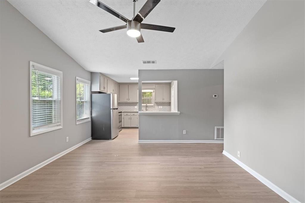 894 Five Forks Trickum Road Southwest Lawrenceville, GA 30046 - Photo 2 of 28 a view of an empty room with a kitchen