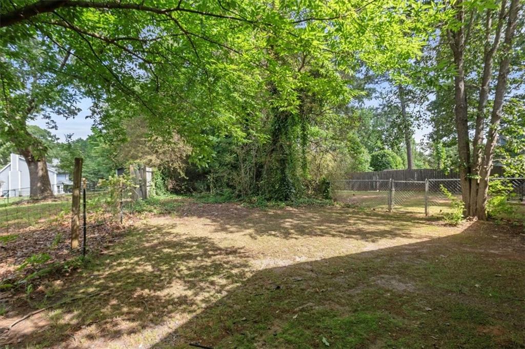 894 Five Forks Trickum Road Southwest Lawrenceville, GA 30046 - Photo 22 of 28 a view of a yard with a tree