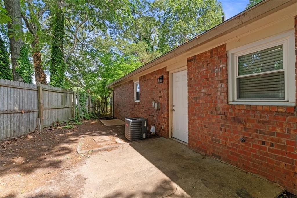 894 Five Forks Trickum Road Southwest Lawrenceville, GA 30046 - Photo 23 of 28 a backyard of a house with barbeque oven and outdoor seating