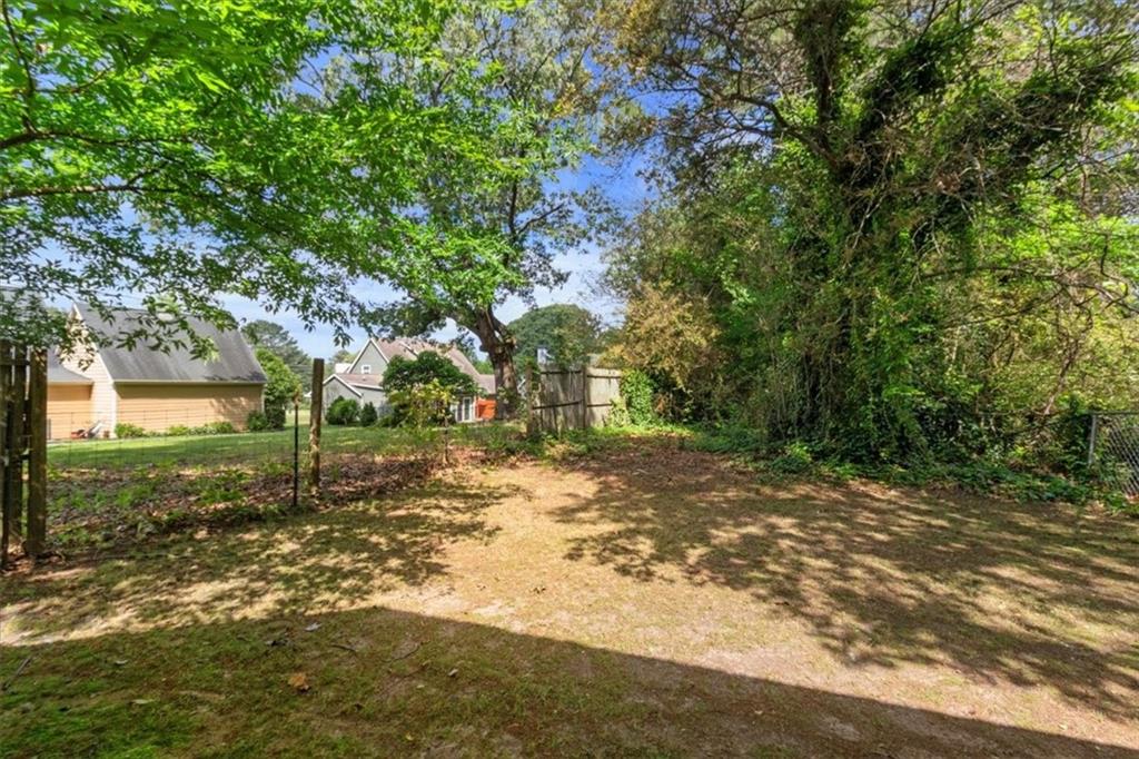 894 Five Forks Trickum Road Southwest Lawrenceville, GA 30046 - Photo 24 of 28 a view of a yard with plants and trees