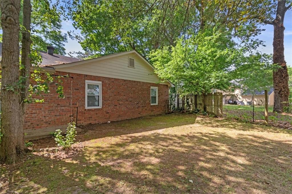 894 Five Forks Trickum Road Southwest Lawrenceville, GA 30046 - Photo 25 of 28 a view of a yard with a house and a tree