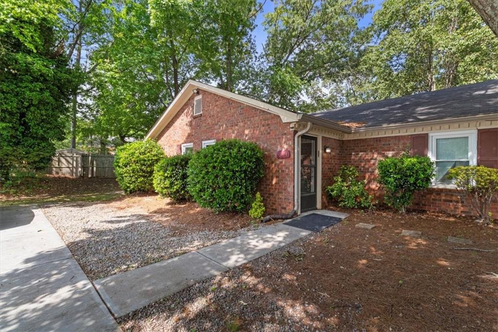 894 Five Forks Trickum Road Southwest Lawrenceville, GA 30046 - Photo 27 of 28 a front view of a house with garden