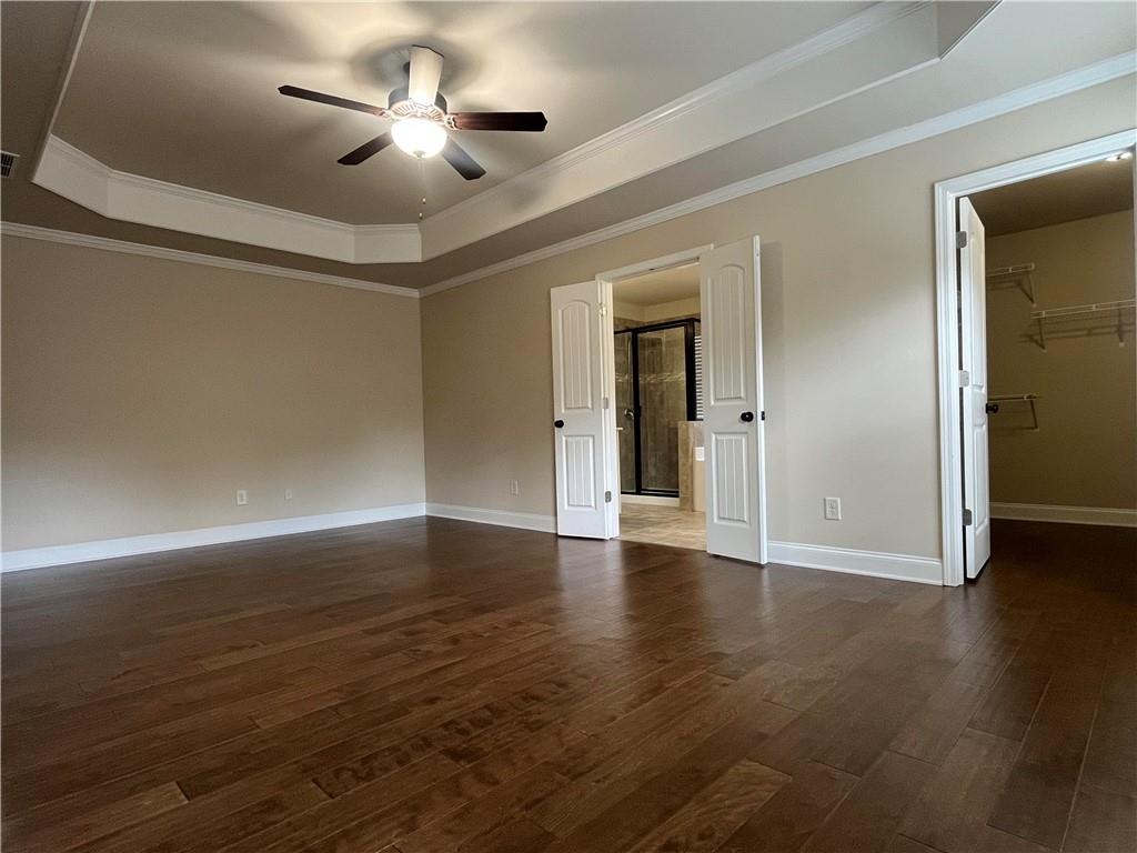 2299 Misty Ivy Court Buford, GA 30519 - Photo 14 of 26 a view of an empty room with wooden floor