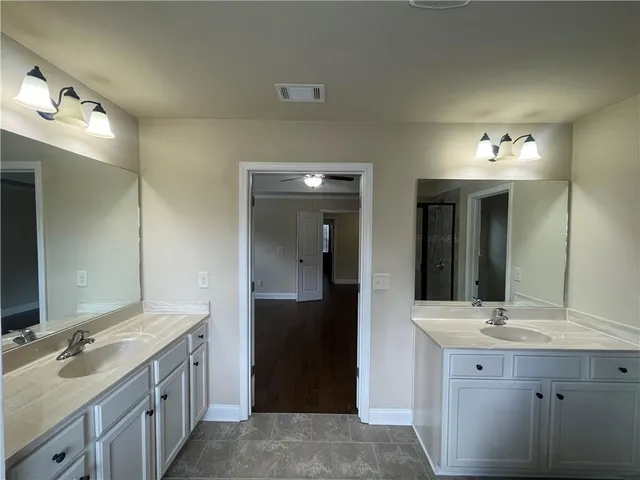 a bathroom with a double vanity sink and mirror