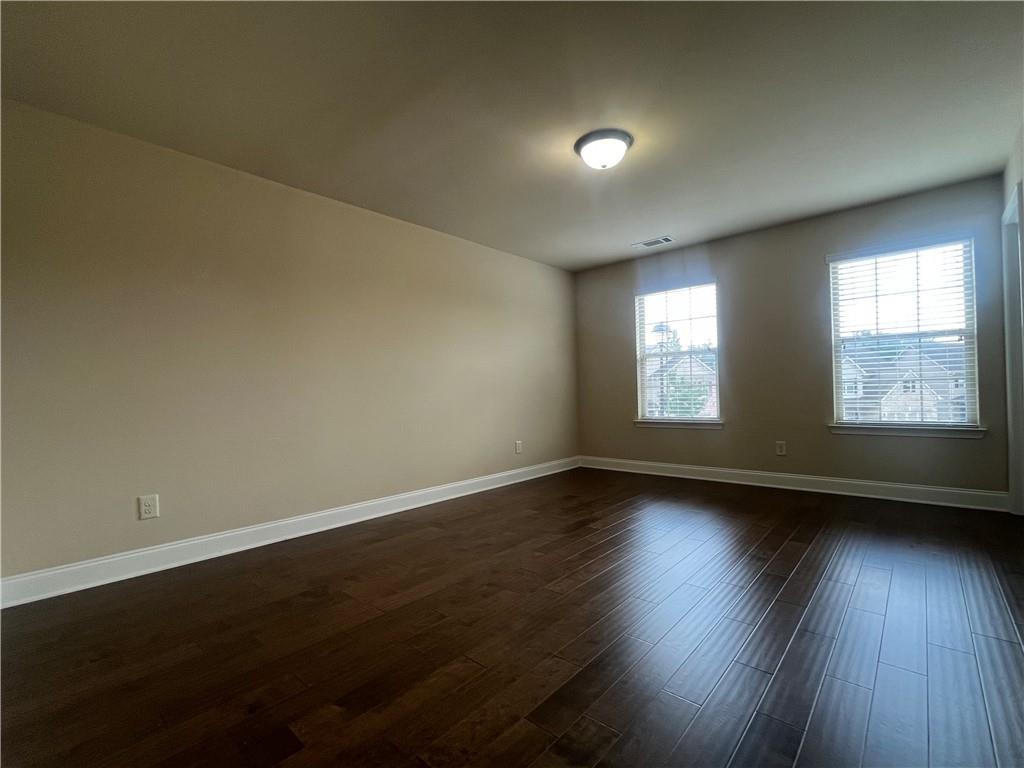 2299 Misty Ivy Court Buford, GA 30519 - Photo 22 of 26 a view of an empty room and wooden floor and window