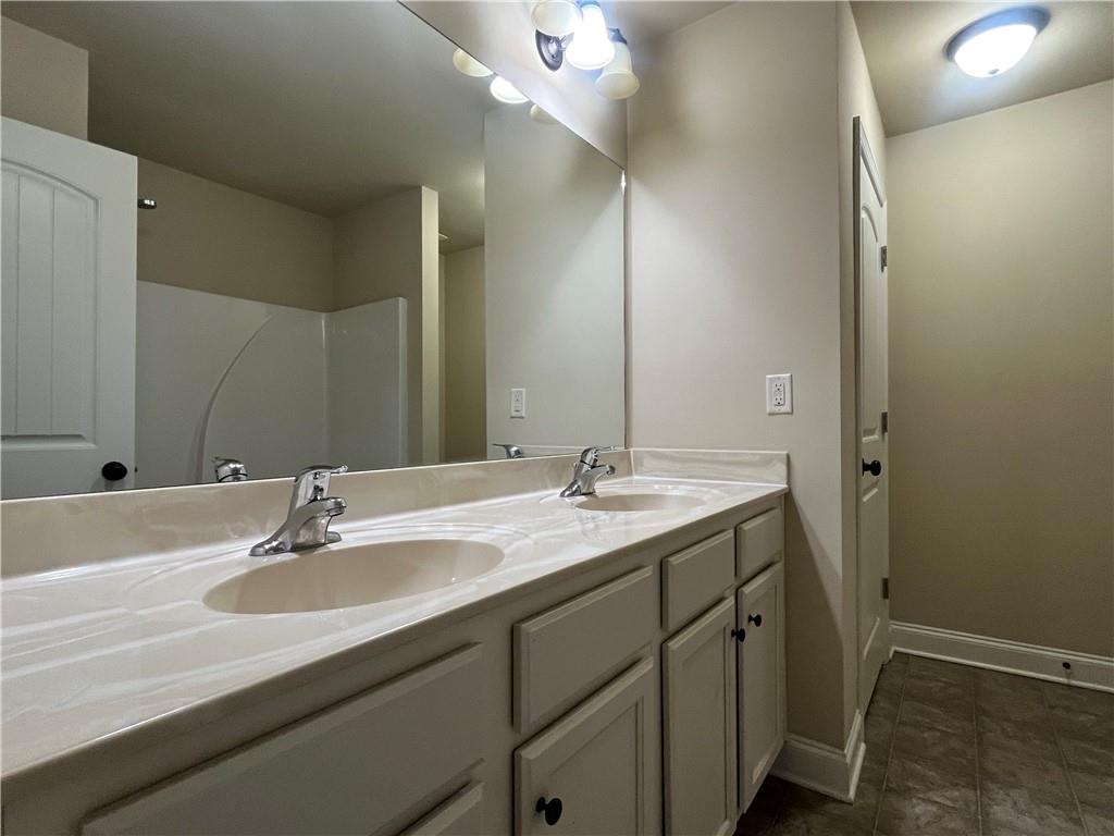 2299 Misty Ivy Court Buford, GA 30519 - Photo 24 of 26 a bathroom with a sink and a mirror
