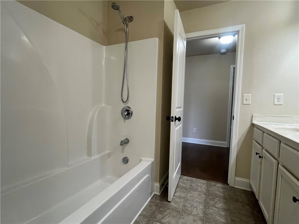2299 Misty Ivy Court Buford, GA 30519 - Photo 25 of 26 a bathroom with a bathtub and a shower
