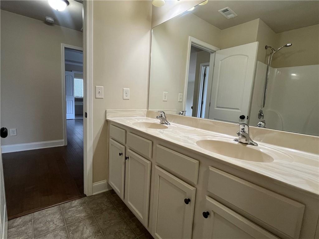 2299 Misty Ivy Court Buford, GA 30519 - Photo 26 of 26 a bathroom with a sink and a mirror
