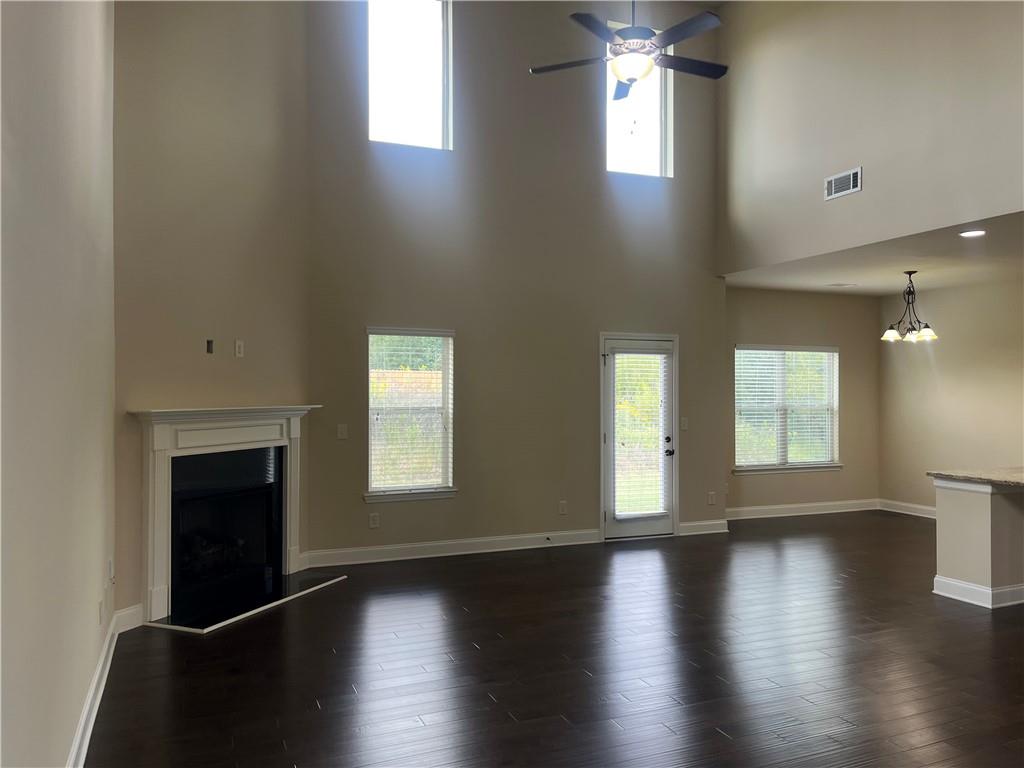 2299 Misty Ivy Court Buford, GA 30519 - Photo 5 of 26 an empty room with wooden floor and windows