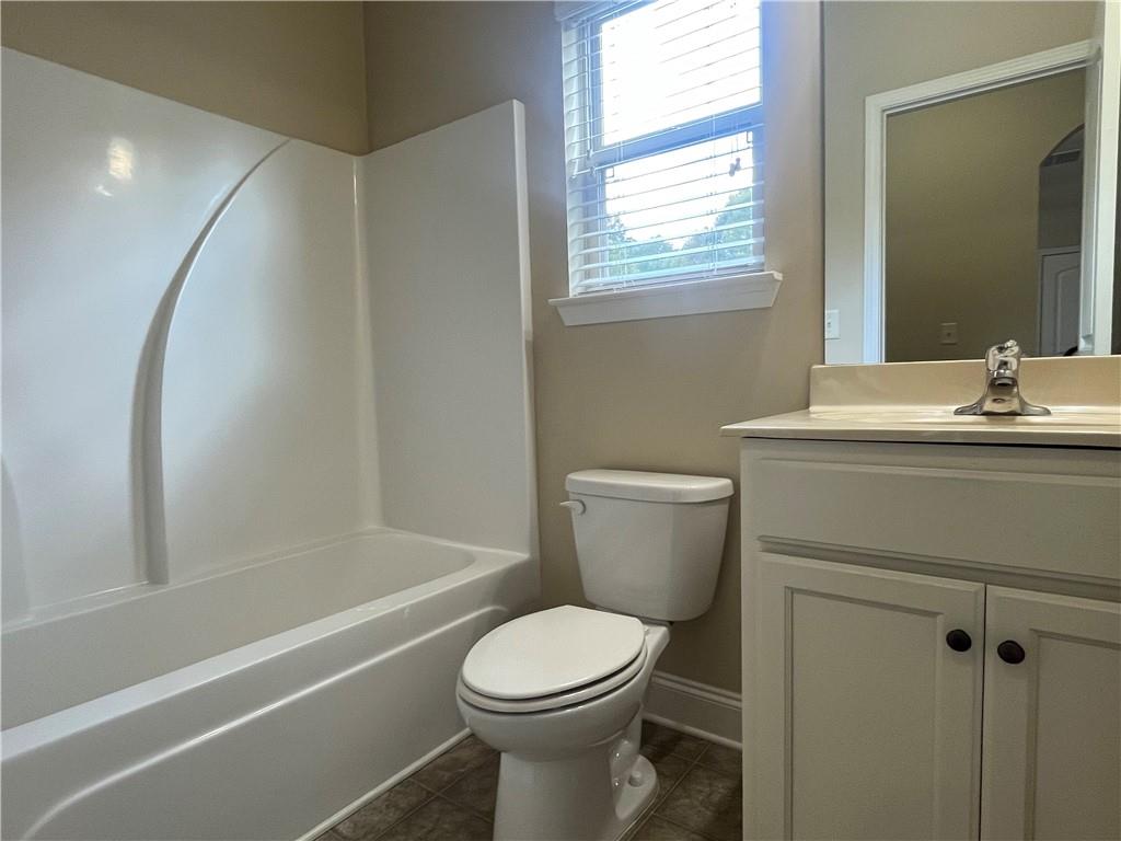 2299 Misty Ivy Court Buford, GA 30519 - Photo 9 of 26 a bathroom with a sink toilet and shower
