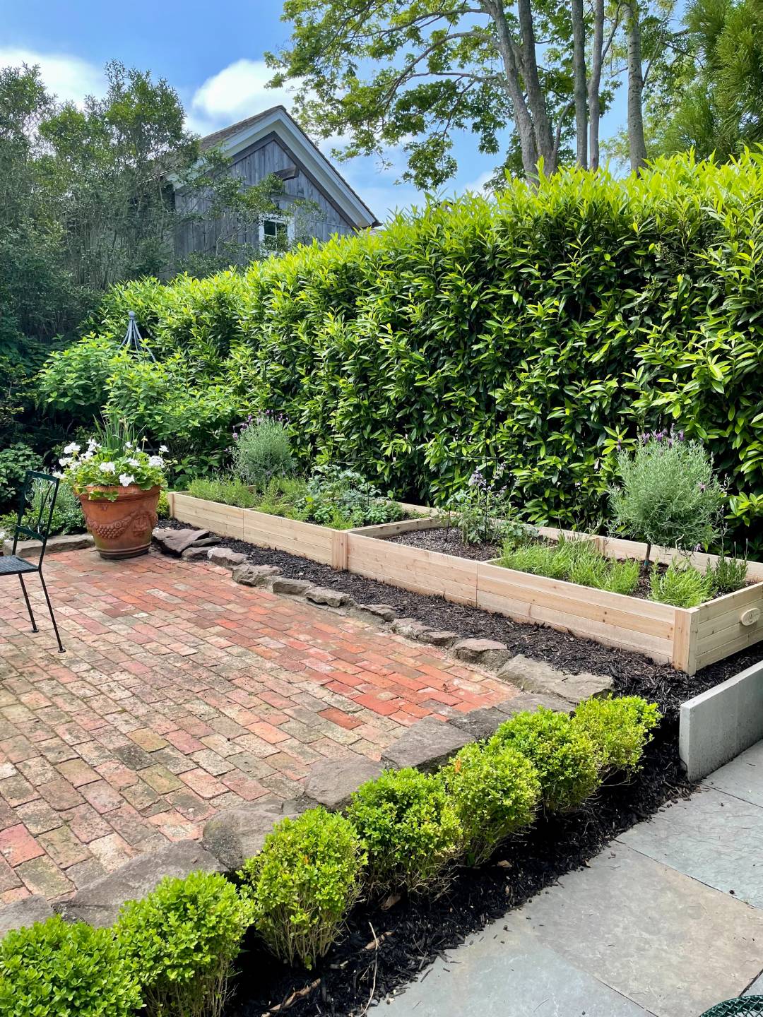 16 Jefferson Street Sag Harbor, NY 11963 - Photo 16 of 22 a view of a garden with a bench