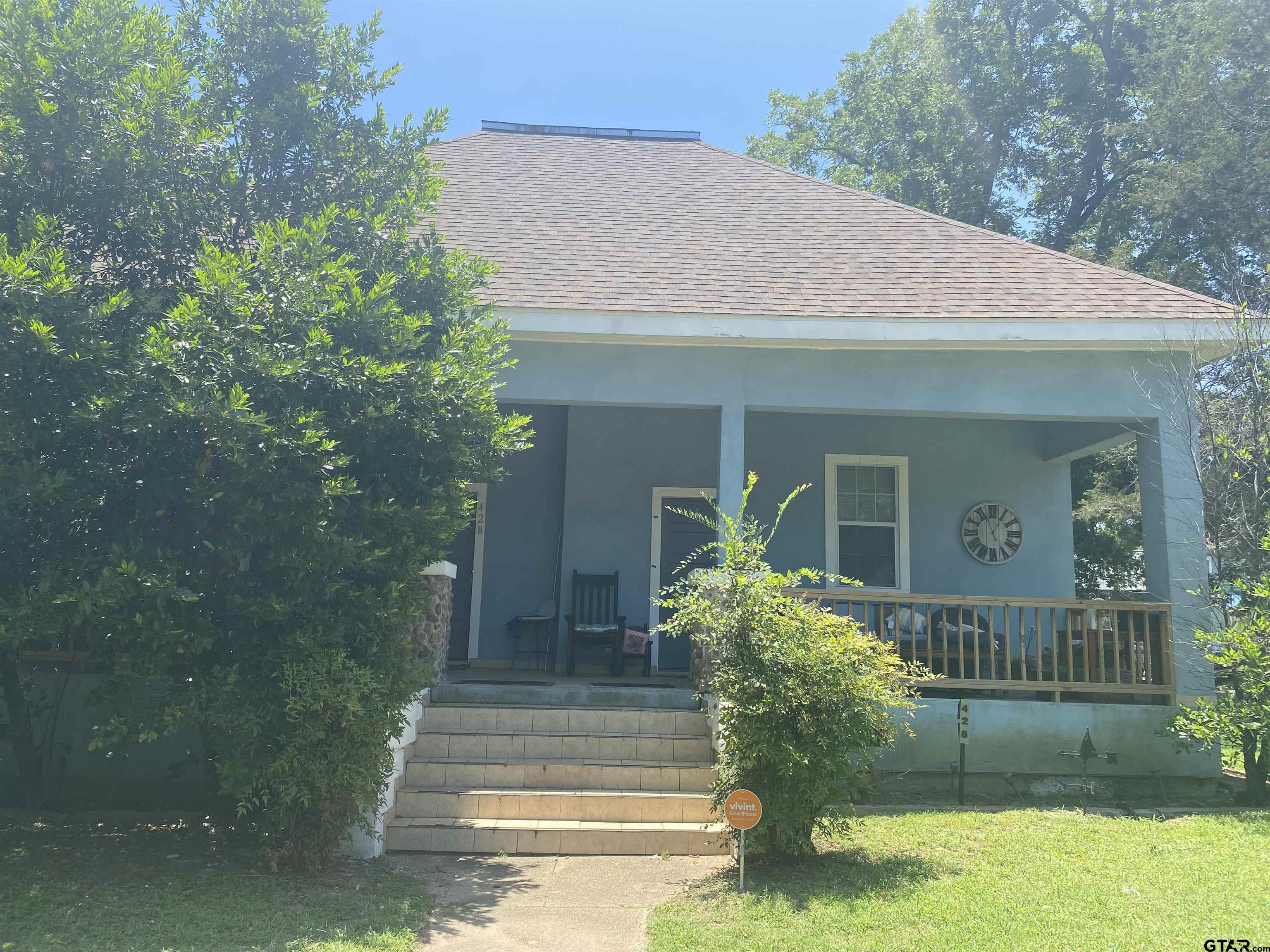 a front view of a house with garden