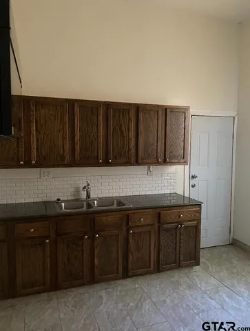 a kitchen with a sink and cabinets