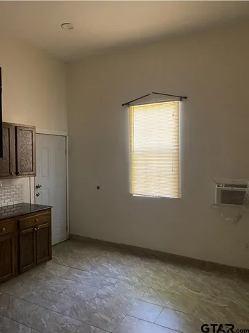 a view of a bathroom with two sinks and a window