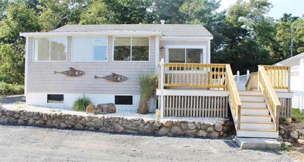 11 Bush Street Wareham, MA 02532 - Photo 1 of 17 a front view of a house with a yard