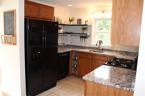 11 Bush Street Wareham, MA 02532 - Photo 4 of 17 a kitchen with a sink a refrigerator and window