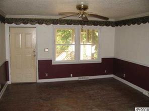 515 Absher Road Bessemer City, NC 28016 - Photo 7 of 16 en empty room with a window and a ceiling fan