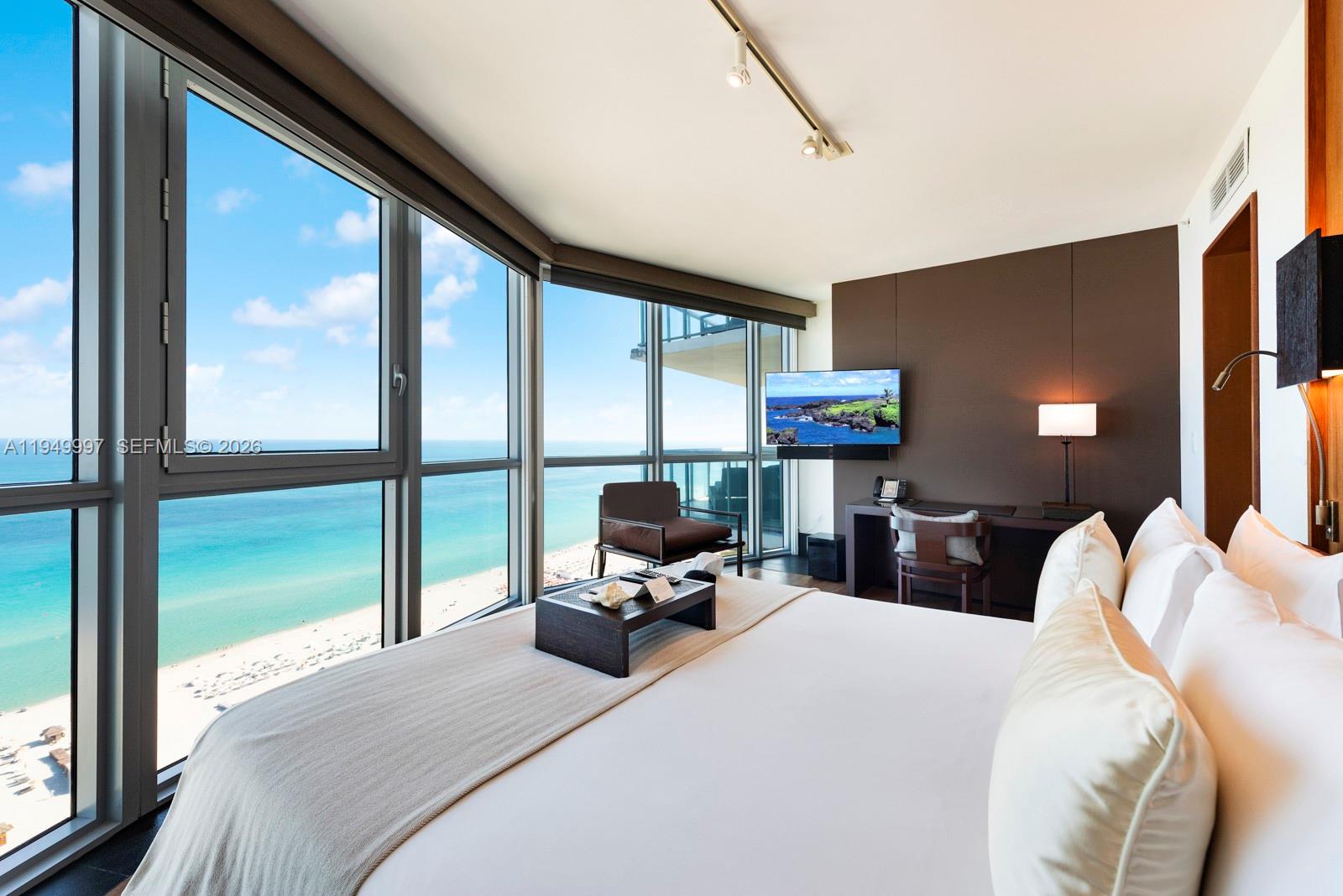 101 20th Street, Unit 3008 Miami Beach, FL 33139 - Photo 12 of 16 a bedroom with a bed and large window