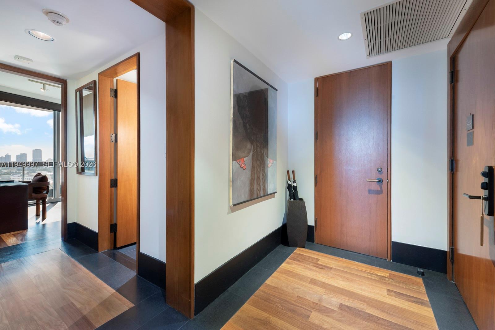 101 20th Street, Unit 3008 Miami Beach, FL 33139 - Photo 14 of 16 a view of a hallway with wooden floor and furniture