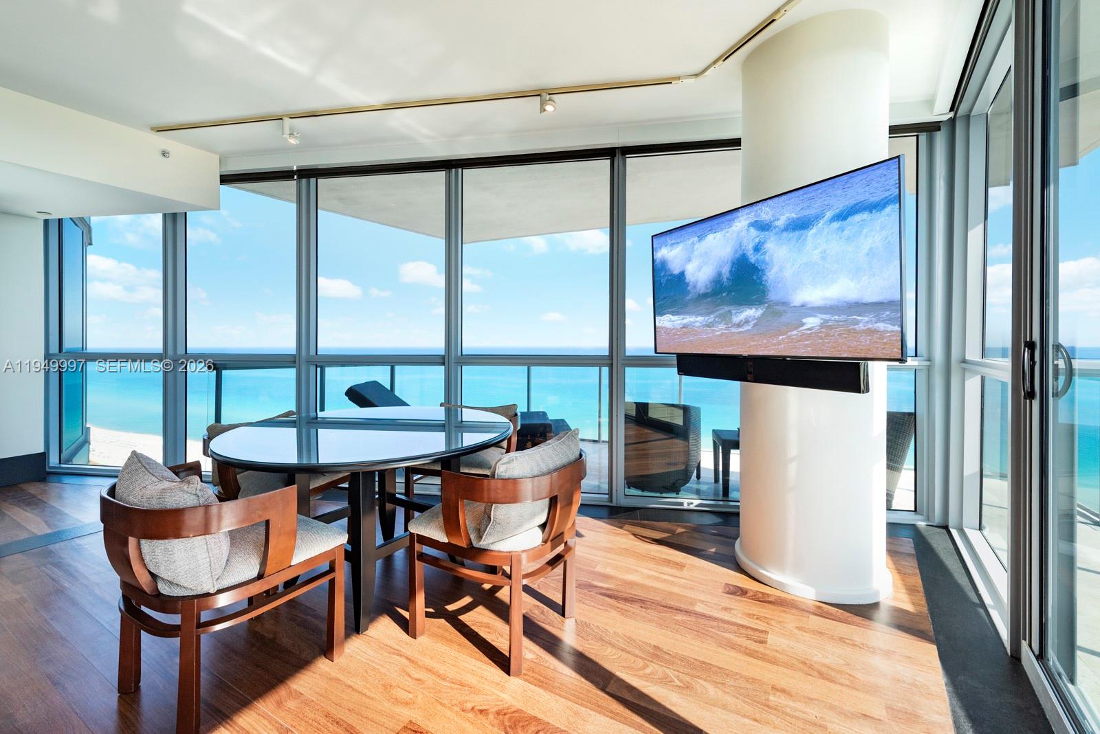 101 20th Street, Unit 3008 Miami Beach, FL 33139 - Photo 3 of 16 a view of a dining room with furniture large window and outside view
