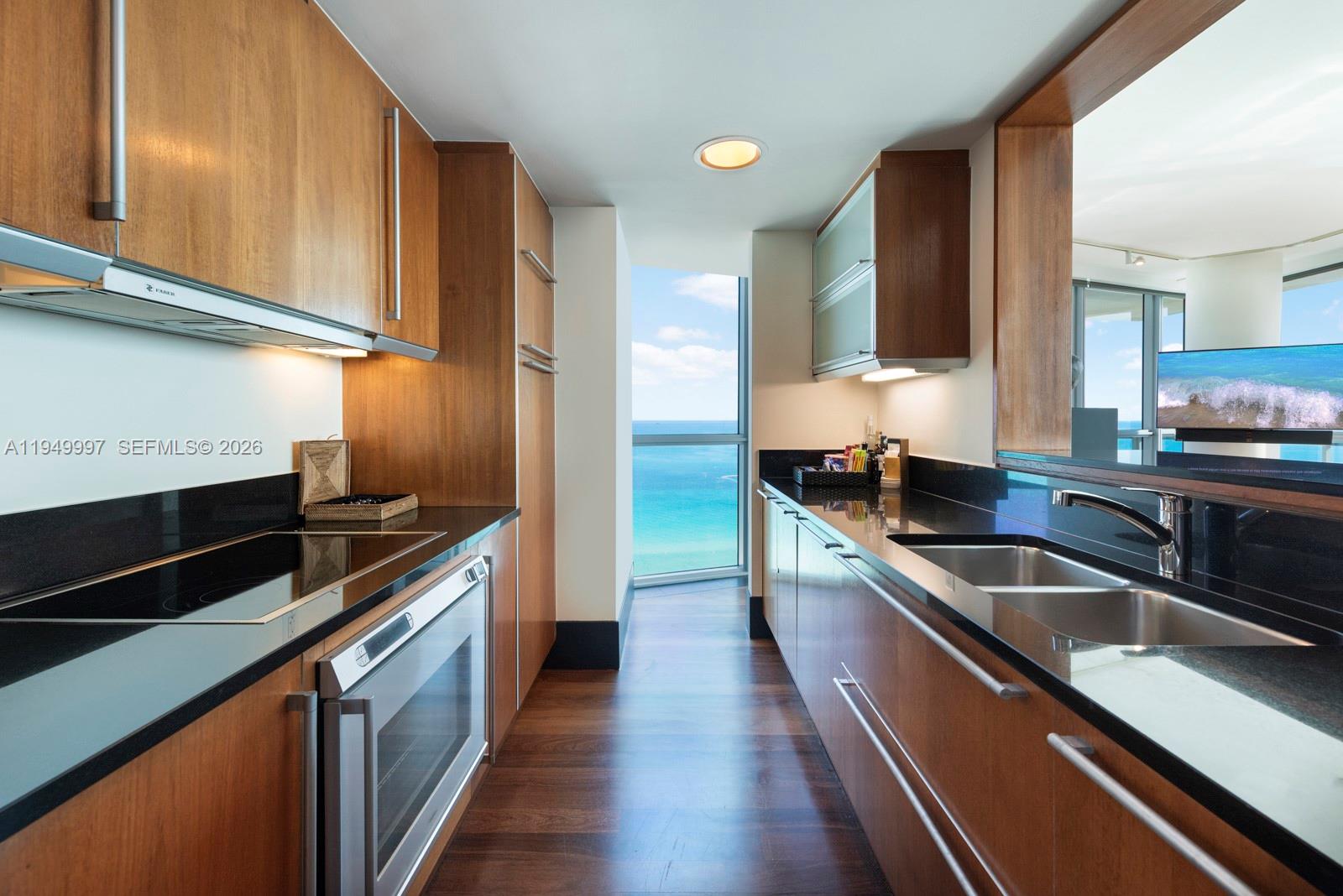 101 20th Street, Unit 3008 Miami Beach, FL 33139 - Photo 9 of 16 a kitchen with stainless steel appliances a sink stove and cabinets