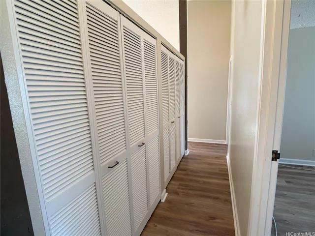 a view of a room with wooden floor