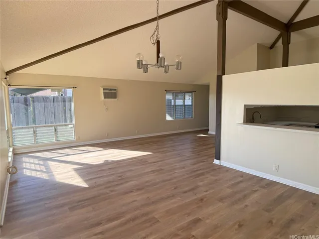a view of a room with wooden floor and white walls