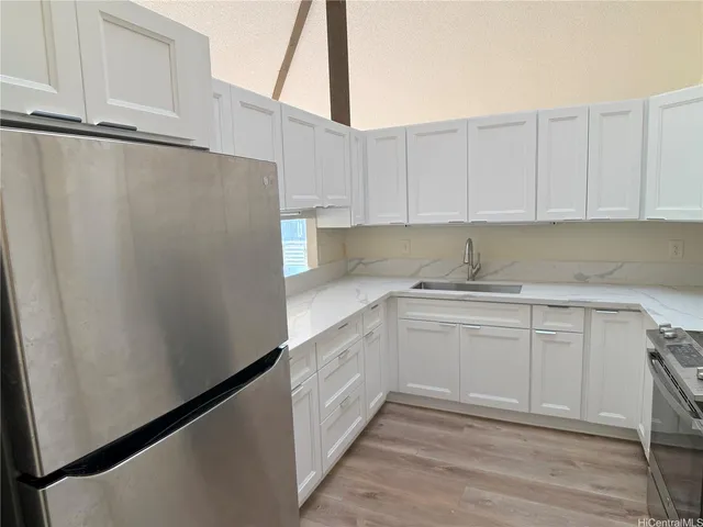 a kitchen with white cabinets and white appliances